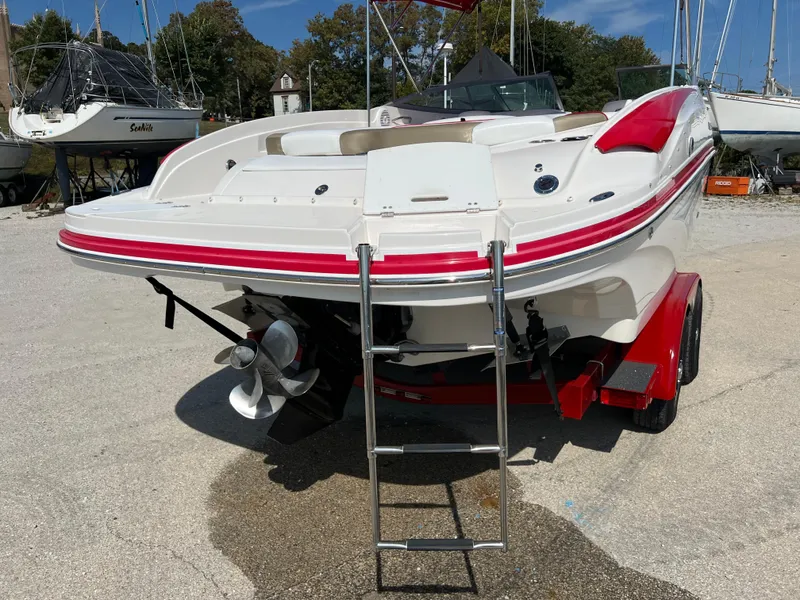 Slide: The Image of 2009 Rinker 246 Captiva Bowrider on trailer, rear view with ladder and propeller visible. - 16