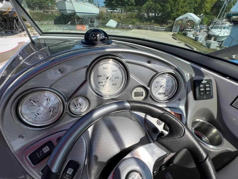 Slide: The Image of 2009 Rinker 246 Captiva Bowrider dashboard with gauges and steering wheel. - 21