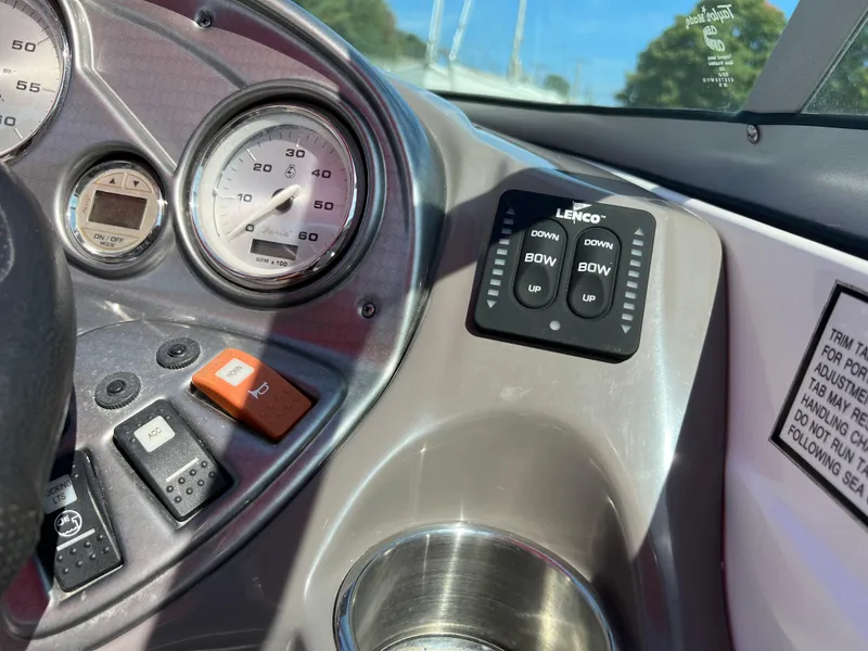 Slide: The Image of Dashboard of 2009 Rinker 246 Captiva Bowrider with gauges and Lenco trim tab controls. - 22