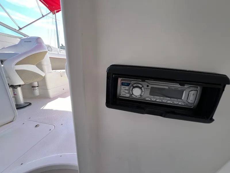 Slide: The Image of 2009 Rinker 246 Captiva Bowrider interior with stereo system and seating area. - 25