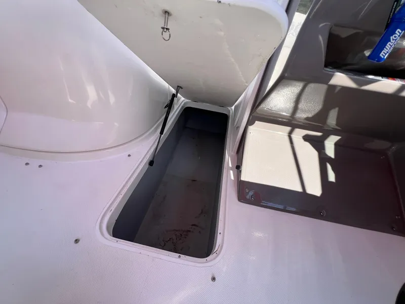 Slide: The Image of Open storage compartment on 2009 Rinker 246 Captiva Bowrider boat interior. - 27
