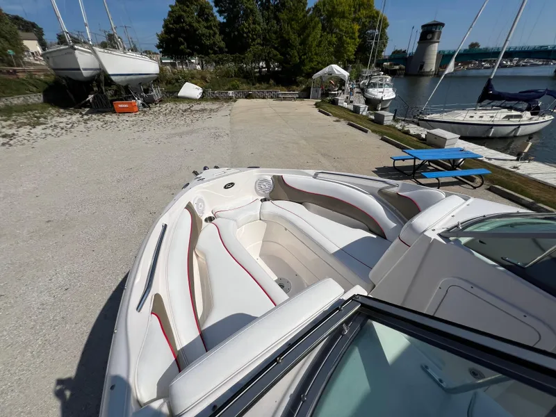 Slide: The Image of 2009 Rinker 246 Captiva Bowrider docked, showcasing spacious seating and sleek design. - 28