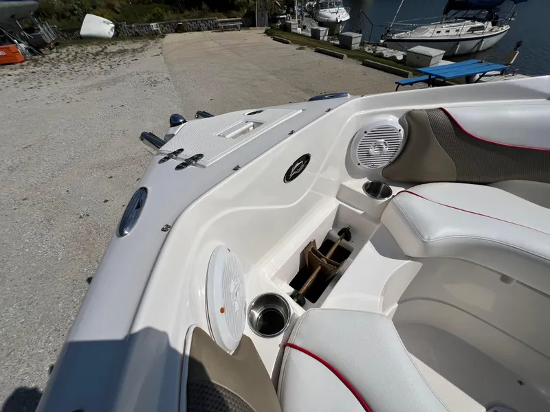 Slide: The Image of 2009 Rinker 246 Captiva Bowrider interior with white seating and cup holders. - 29