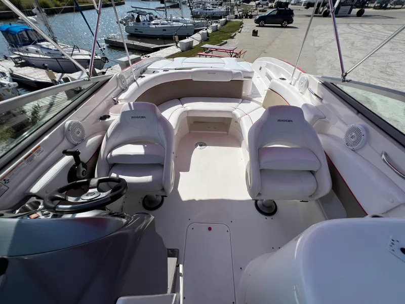 Slide: The Image of 2009 Rinker 246 Captiva Bowrider interior with seating, docked at marina. - 31