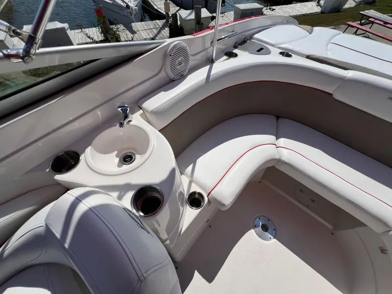 Slide: The Image of 2009 Rinker 246 Captiva Bowrider interior with white seating and built-in sink. - 32