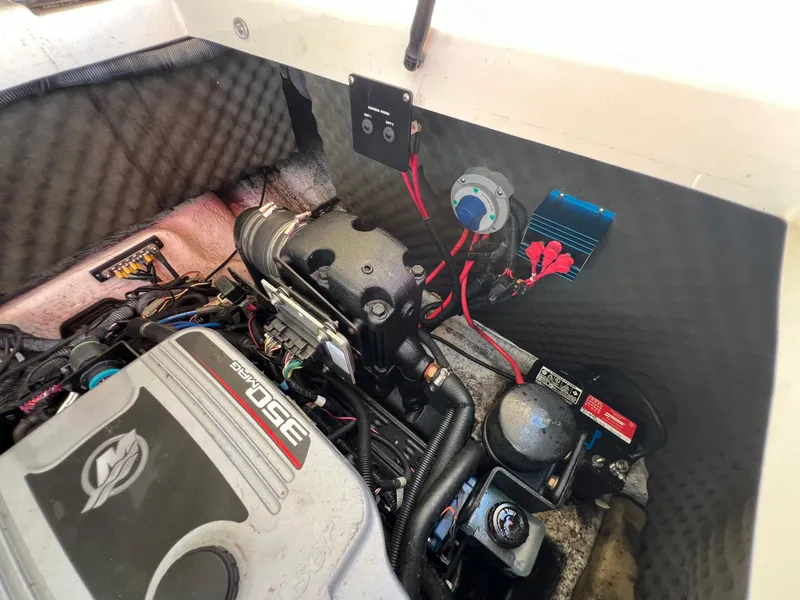 Slide: The Image of Engine compartment of a 2009 Rinker 246 Captiva Bowrider, showcasing mechanical components. - 37