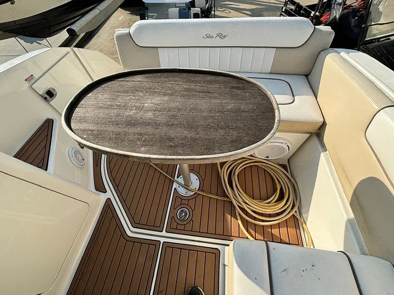 Slide: The Image of 2012 Sea Ray 260 Sundancer boat interior with table and seating area. - 13