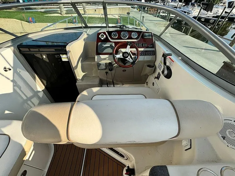 Slide: The Image of 2012 Sea Ray 260 Sundancer cockpit with steering wheel and control panel. - 16