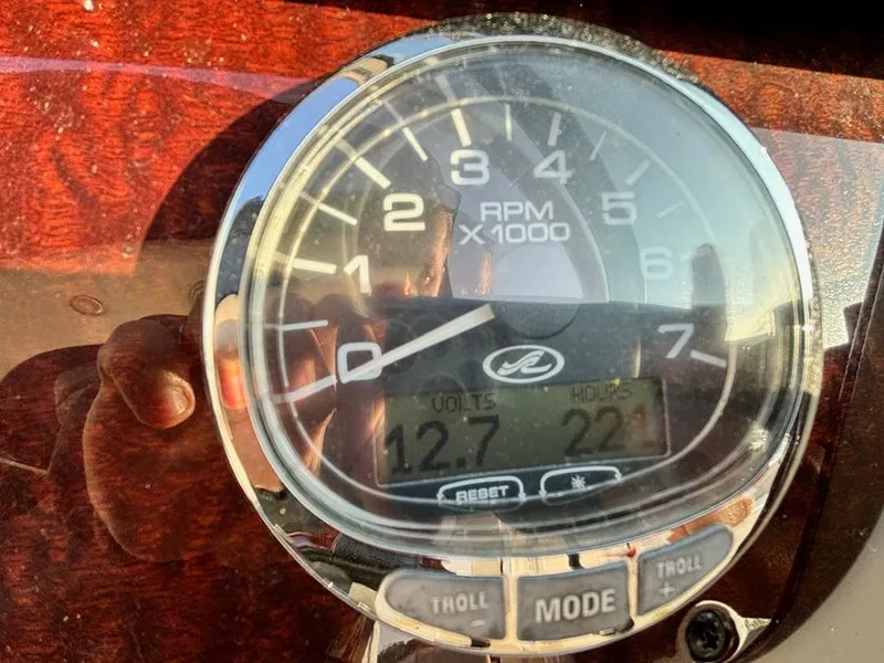 Slide: The Image of Close-up of a 2012 Sea Ray 260 Sundancer tachometer showing RPM and voltage readings. - 6