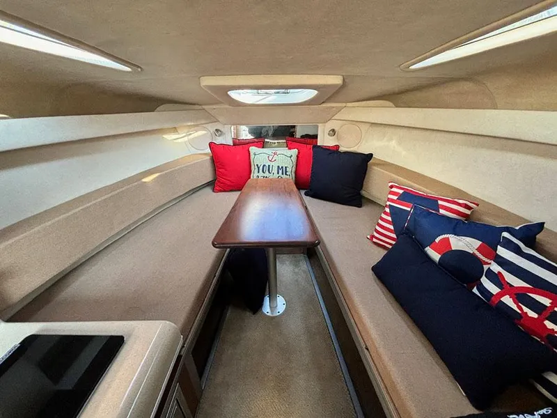 Slide: The Image of Cozy interior of 2012 Sea Ray 260 Sundancer with cushions and table. - 8