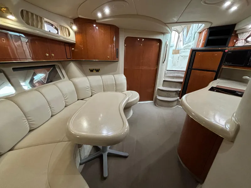 Slide: The Image of Luxurious interior of 1998 Sea Ray 400 Sundancer yacht with elegant seating and cabinetry. - 13