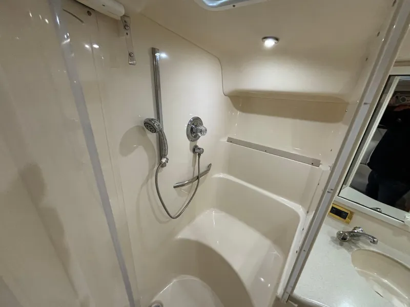 Slide: The Image of 1998 Sea Ray 400 Sundancer bathroom with shower, sink, and modern fixtures. - 19