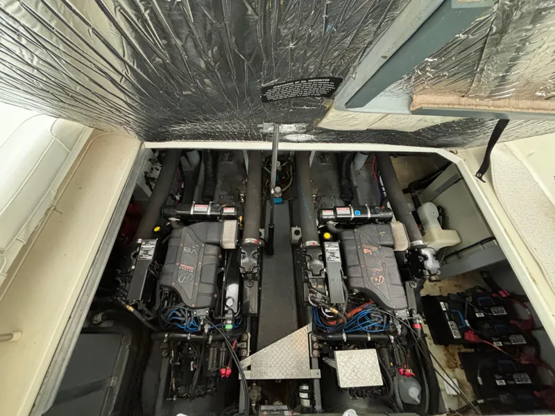 Slide: The Image of Engine room of a 1998 Sea Ray 400 Sundancer with dual engines and insulated ceiling. - 22