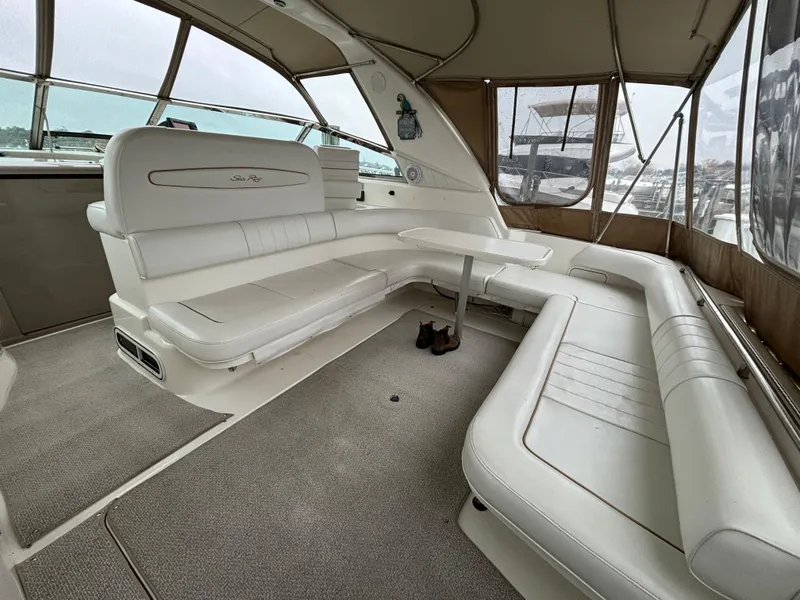 Slide: The Image of Spacious interior of 1998 Sea Ray 400 Sundancer with white seating and panoramic windows. - 5