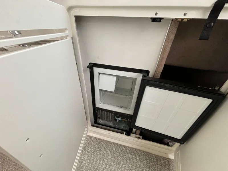Slide: The Image of 1998 Sea Ray 400 Sundancer interior fridge compartment, open door view. - 7