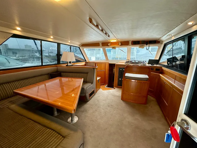 Slide: The Image of Interior of a 1998 Riviera 43 yacht with dining area and helm station. - 13