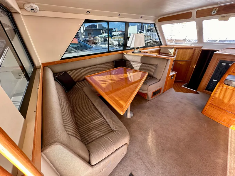 Slide: The Image of Interior of 1998 Riviera 43 yacht with plush seating and wooden table. - 14