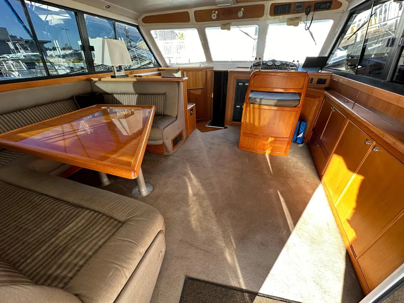 Slide: The Image of Interior of 1998 Riviera 43 yacht with wooden furnishings and seating area. - 15