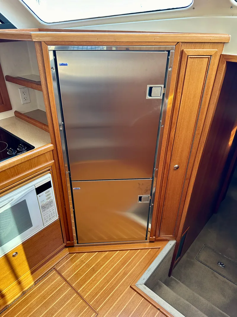 Slide: The Image of Stainless steel refrigerator in 1998 Riviera 43 yacht kitchen interior. - 17