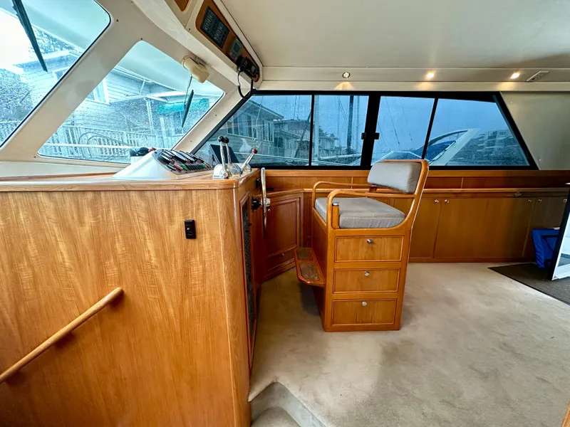 Slide: The Image of Interior of 1998 Riviera 43 yacht with wooden helm and seating area. - 21