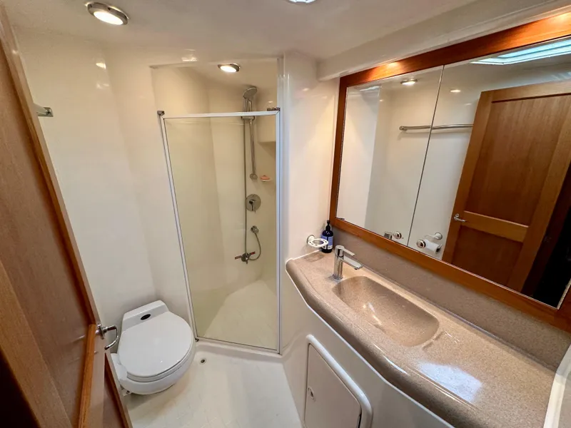 Slide: The Image of Luxurious bathroom in 1998 Riviera 43 yacht with shower, sink, and toilet. - 26
