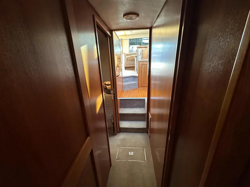Slide: The Image of Interior hallway of a 1998 Riviera 43 yacht with wooden paneling. - 29