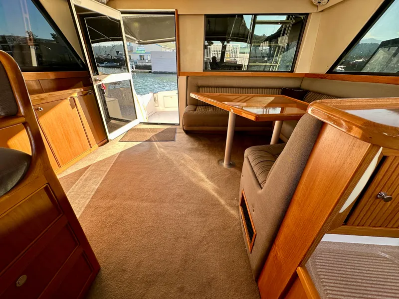 Slide: The Image of Interior of 1998 Riviera 43 yacht with wooden furnishings and seating area. - 30