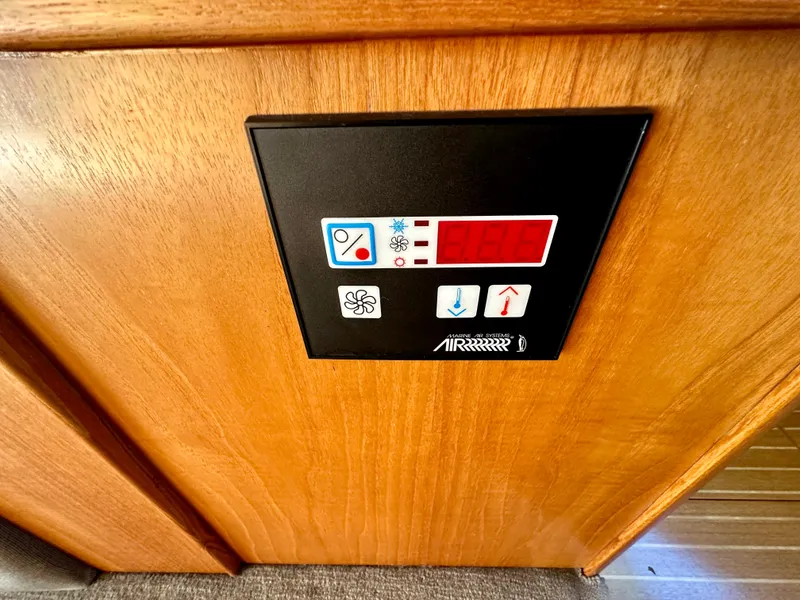 Slide: The Image of Control panel on a 1998 Riviera 43 boat, featuring temperature and fan settings. - 31