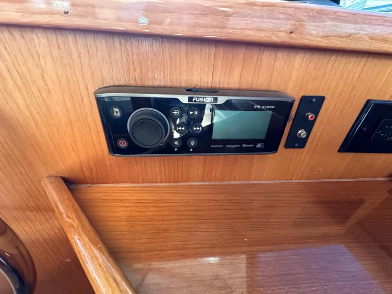 Slide: The Image of Fusion marine stereo system on a 1998 Riviera 43 yacht's wooden dashboard. - 32