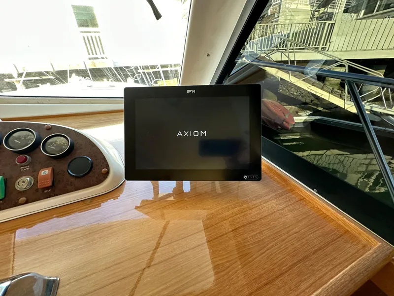 Slide: The Image of Dashboard of a 1998 Riviera 43 yacht featuring an Axiom display screen. - 33