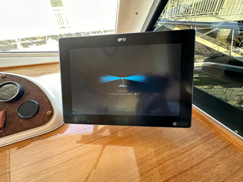 Slide: The Image of Touchscreen display on 1998 Riviera 43 yacht dashboard, showing "Lighthouse 4" interface. - 35