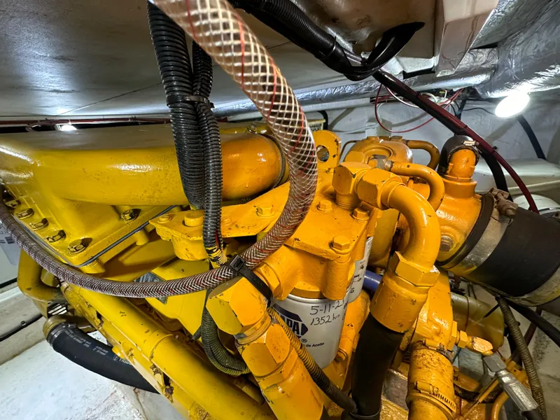 Slide: The Image of Engine compartment of a 1998 Riviera 43 boat, featuring yellow mechanical components. - 37