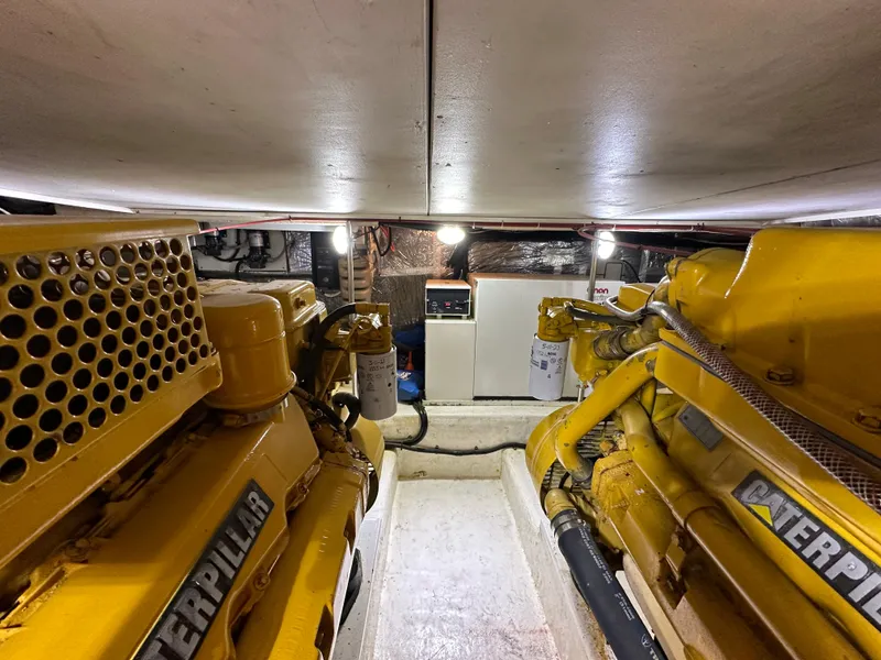 Slide: The Image of Engine room of 1998 Riviera 43 with Caterpillar engines, well-lit and organized. - 38