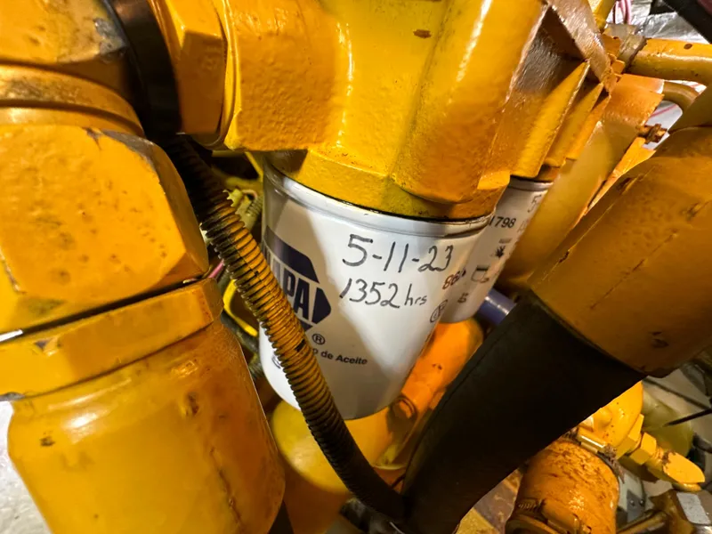 Slide: The Image of Oil filter with maintenance date and hours on a 1998 Riviera 43 engine. - 41