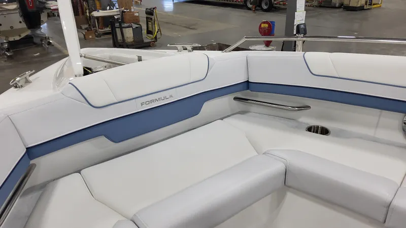 Slide: The Image of 2025 Formula 330 Crossover Bowrider OB interior with white and blue seating. - 15