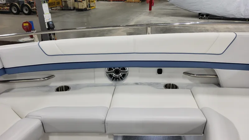 Slide: The Image of 2025 Formula 330 Crossover Bowrider OB interior seating with cup holders and speaker. - 16