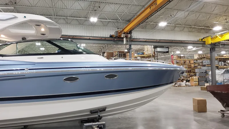 Slide: The Image of 2025 Formula 330 Crossover Bowrider OB in warehouse setting. - 2