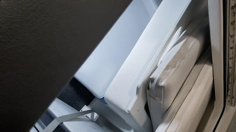 Slide: The Image of Interior seating of 2025 Formula 330 Crossover Bowrider OB, featuring white cushions. - 22