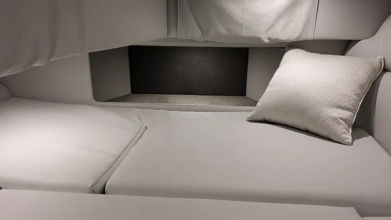 Slide: The Image of 2025 Formula 330 Crossover Bowrider OB cabin interior with plush bedding. - 26