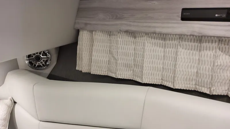 Slide: The Image of 2025 Formula 330 Crossover Bowrider OB interior with white seating and speaker. - 29