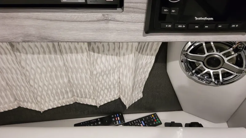 Slide: The Image of 2025 Formula 330 Crossover Bowrider OB interior with speaker and remote controls. - 30