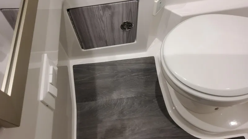 Slide: The Image of 2025 Formula 330 Crossover Bowrider OB bathroom with modern design and wood accents. - 34