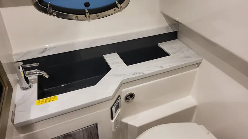 Slide: The Image of 2025 Formula 330 Crossover Bowrider OB bathroom with sleek countertop and modern fixtures. - 35