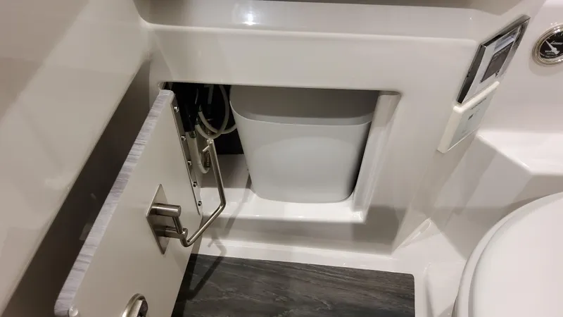 Slide: The Image of 2025 Formula 330 Crossover Bowrider OB bathroom storage compartment with sleek design. - 37