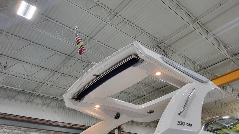 Slide: The Image of 2025 Formula 330 Crossover Bowrider OB in a showroom, showcasing sleek design and lighting. - 4