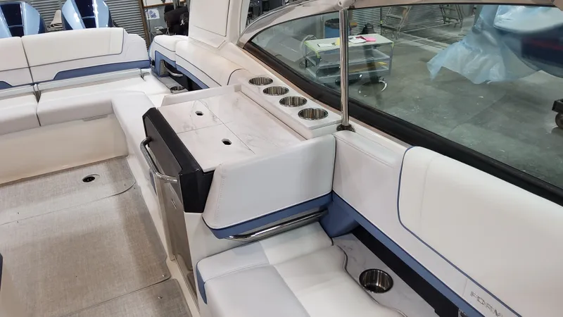 Slide: The Image of 2025 Formula 330 Crossover Bowrider OB interior with white seating and cup holders. - 41