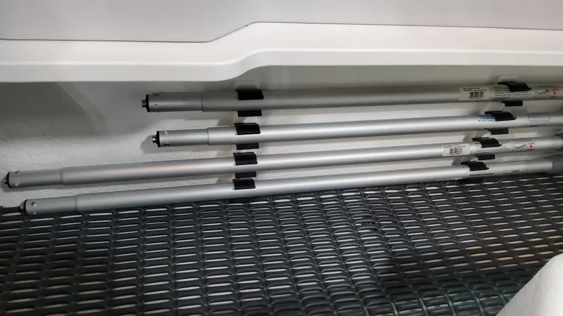 Slide: The Image of Storage compartment with poles in 2025 Formula 330 Crossover Bowrider OB boat. - 43