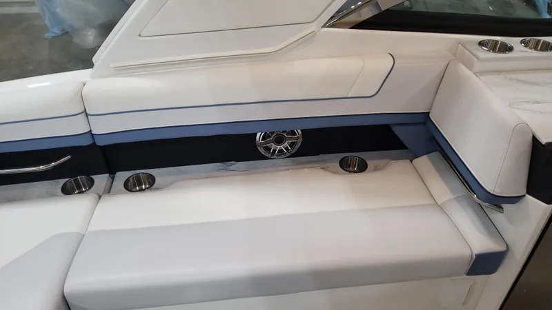 Slide: The Image of 2025 Formula 330 Crossover Bowrider OB interior seating with cup holders and speaker. - 47