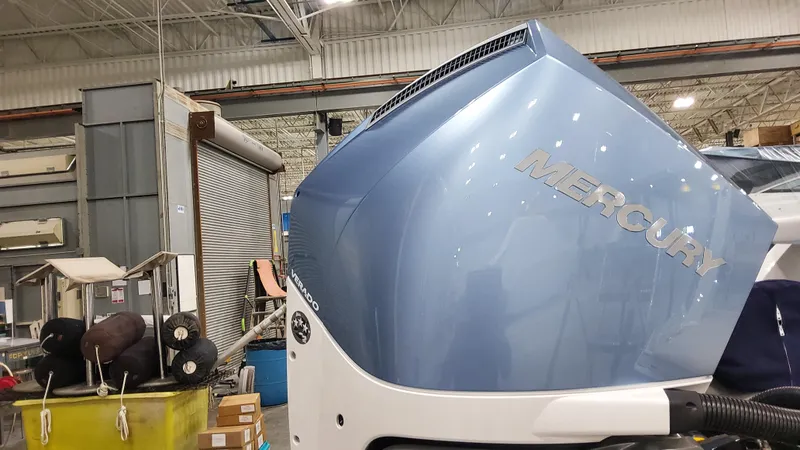 Slide: The Image of 2025 Formula 330 Crossover Bowrider OB with Mercury outboard engine in a workshop. - 8