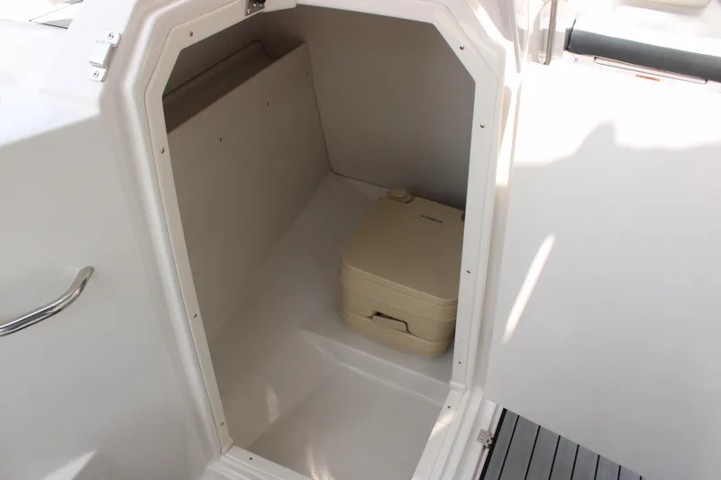 Slide: The Image of Compact cabin space with portable toilet in 2025 Starcraft 230 boat. - 10